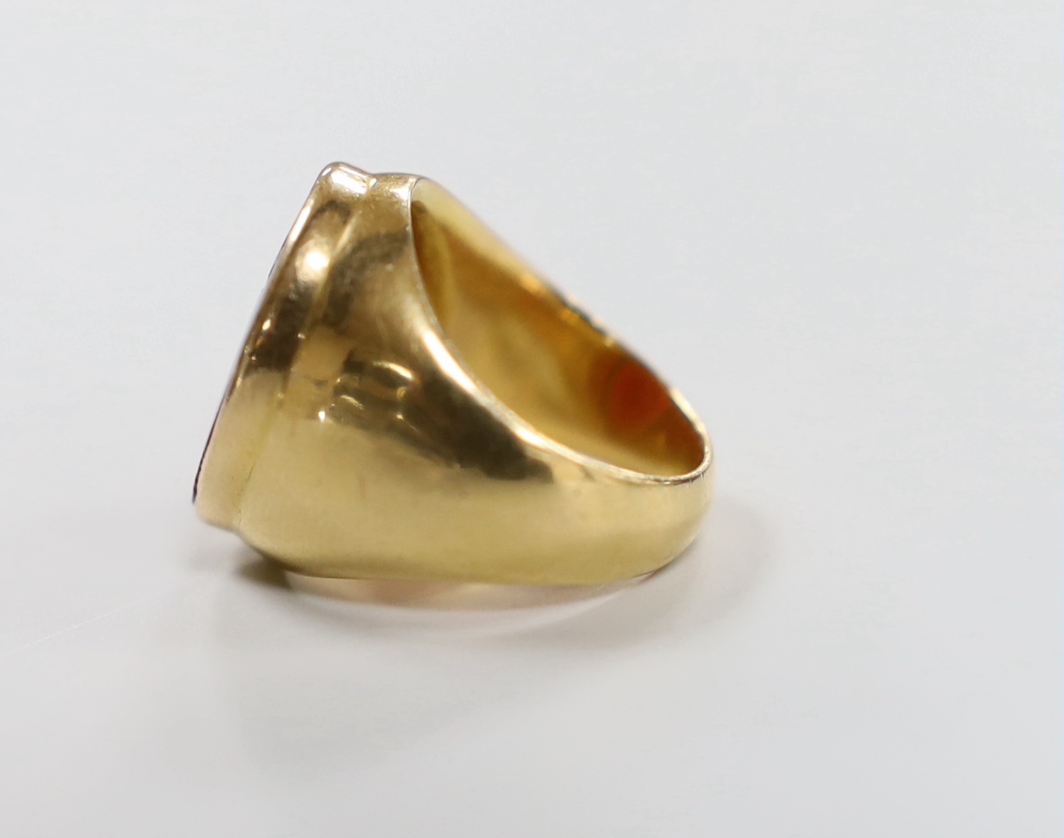 An antique yellow metal intaglio carnelian set ring, carved with a Roman soldier, size F/G, gross weight 11.1 grams.